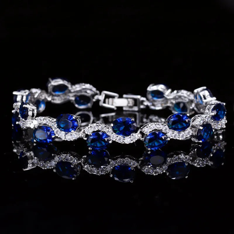Close-up of a geometric style copper plated gold bracelet with micro inlaid white zircon stones, showing clasp detail.
