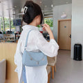 Women's black PU leather butterfly chain crossbody bag with convertible strap showing internal organisation compartments