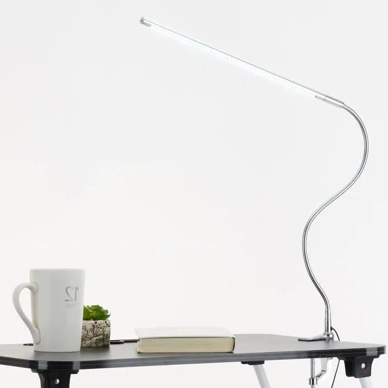 Silver aluminium LED nail lamp with long adjustable arm and clip mounting for workstation illumination
