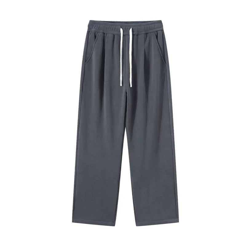 Men's apricot coloured loose-fit fleece-lined winter sports trousers with a drawstring waist laid flat.