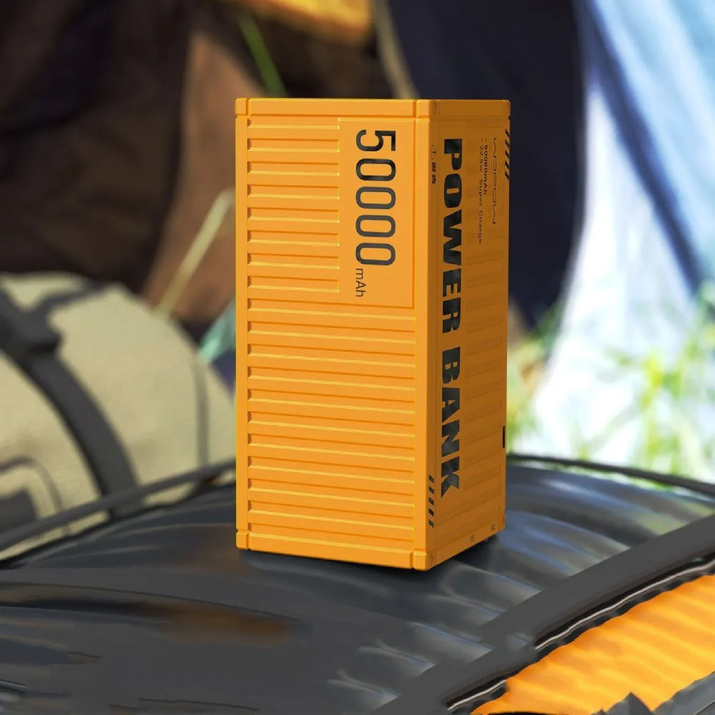 Yellow 50000mAh portable power bank with digital display showing battery percentage and five output ports.