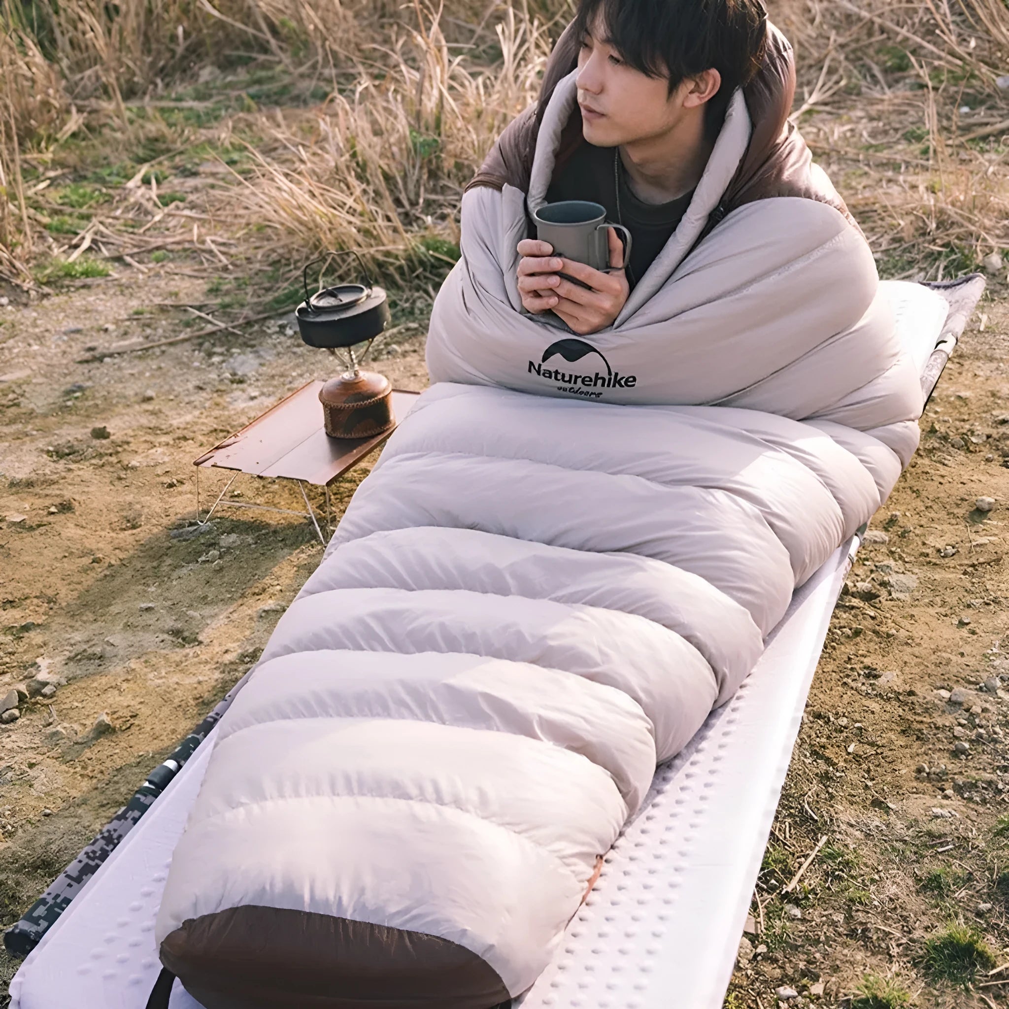 Goose down mummy sleeping bag for adults shown in storage bag with size and weight options displayed