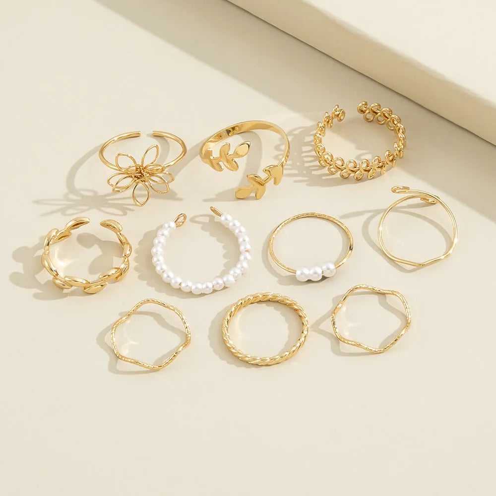 Gold tone openwork flower design alloy ring for women with glossy electroplated finish