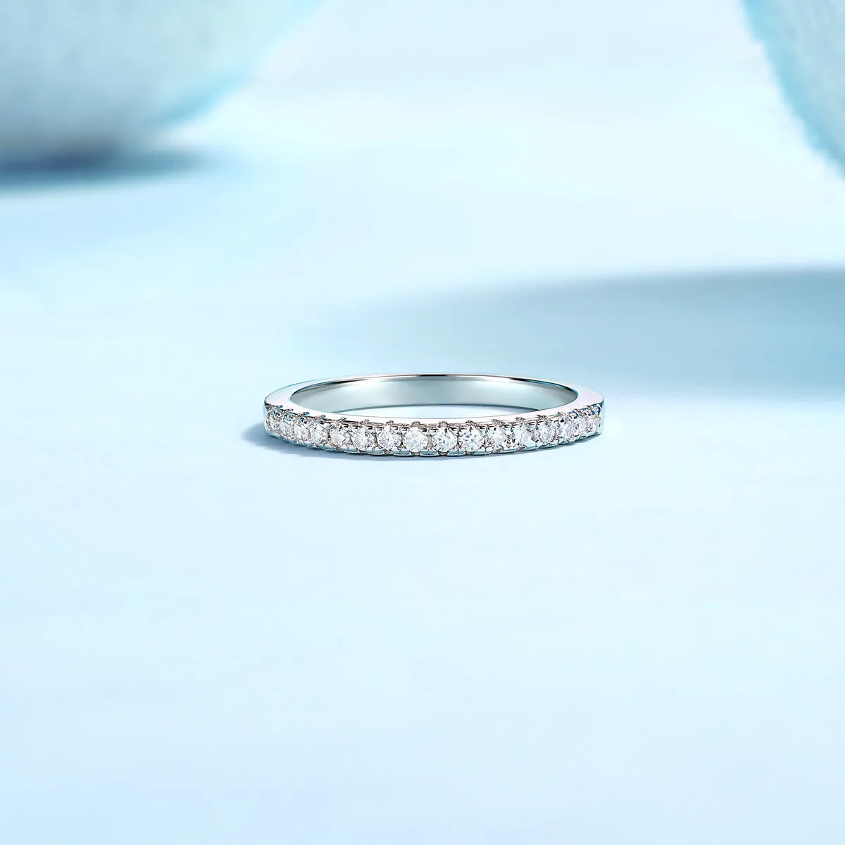 Parallel World moissanite wedding ring set in gold and rose gold on a gift box