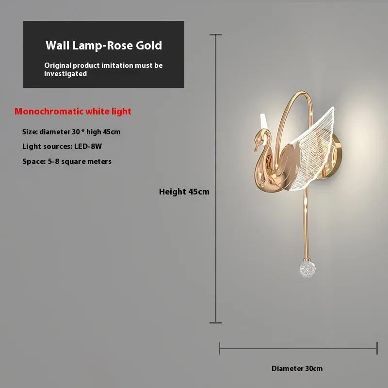 Gold swan-shaped modern minimalist wall lamp with acrylic shade on a wall.
