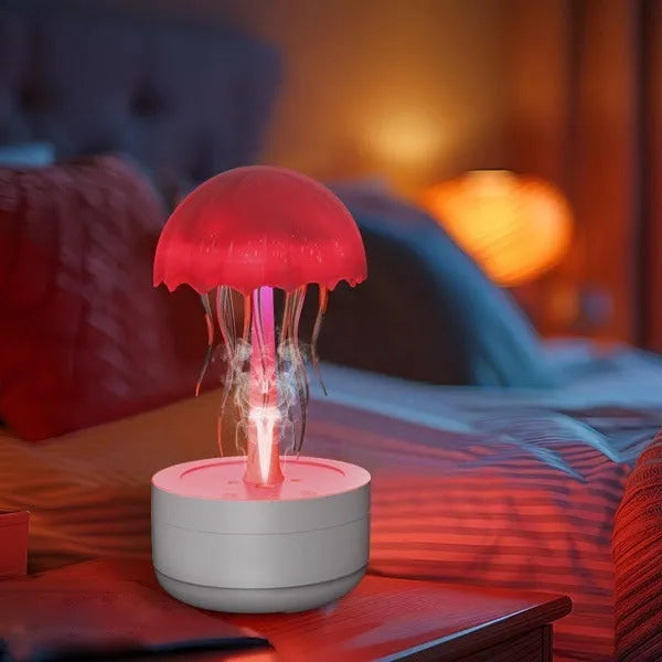 White jellyfish-shaped humidifier and essential oil diffuser with colourful night light on a desk.