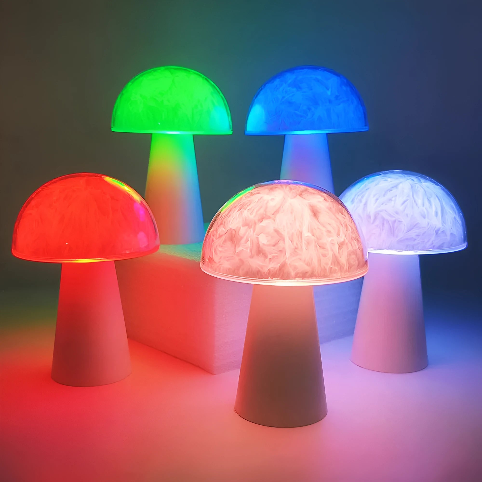 Small white mushroom-shaped night light with colourful RGB glow on a wooden table.