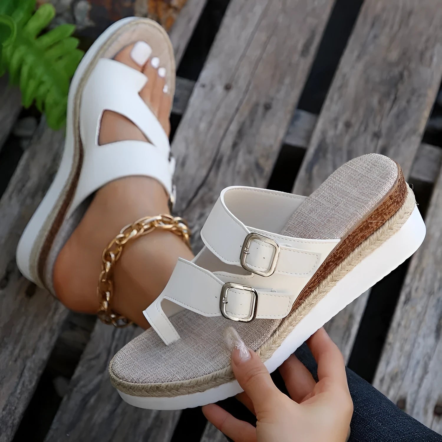White woven patent leather wedge sandals with a peep toe and finger-fit strap design.