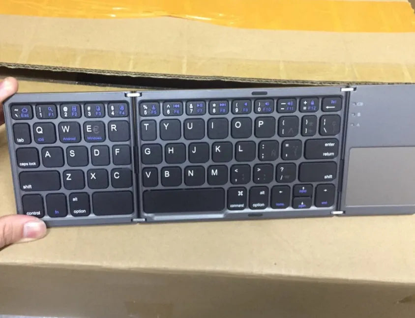 Tri-fold folding Bluetooth keyboard shown both open and closed, with integrated touchpad