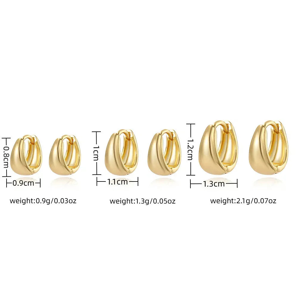 Drop-shaped copper earrings set of three sizes in gold finish on a white background