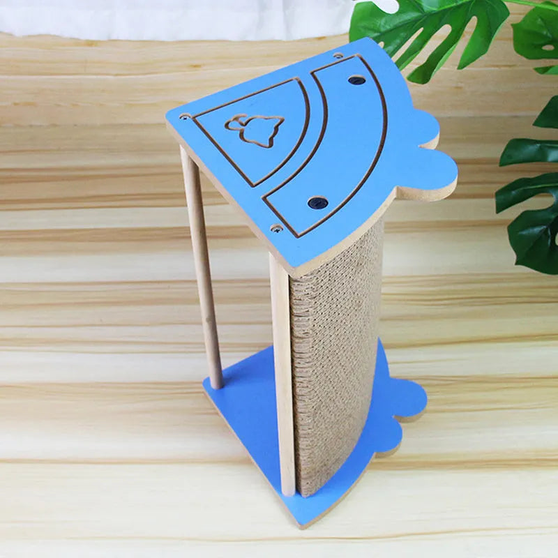 Corner-shaped cardboard cat scratching pad with a hanging ball attached, placed in a room corner.