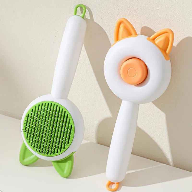 Self-cleaning cat grooming brush with stainless steel pins in greenish white and orange white colour options