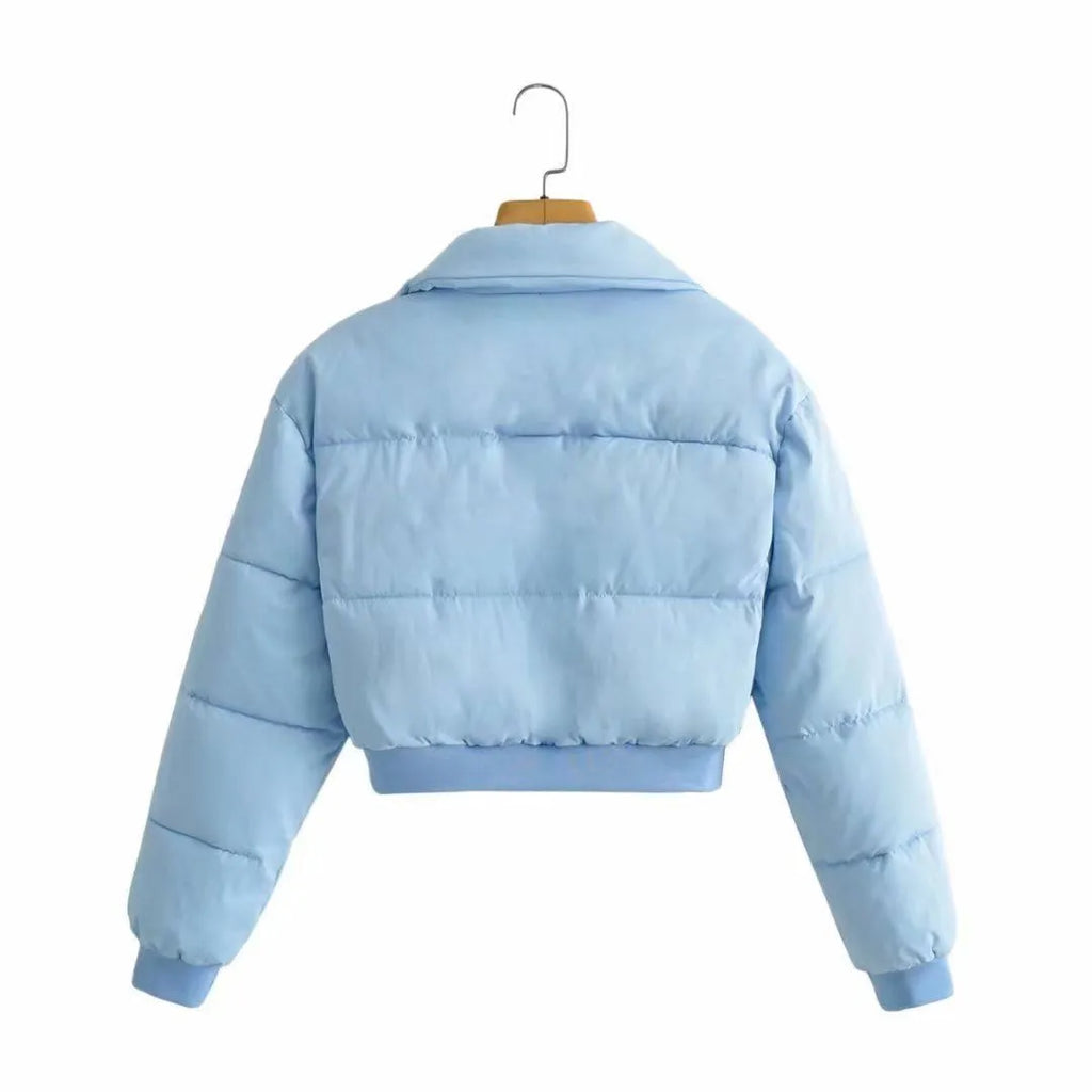 Women's loose blue polyester jacket with long sleeves on a hanger