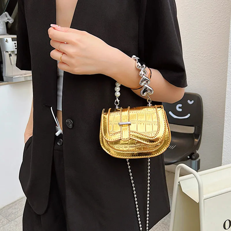 Silver laser pearl tote saddle mini crossbody bag for women on a model