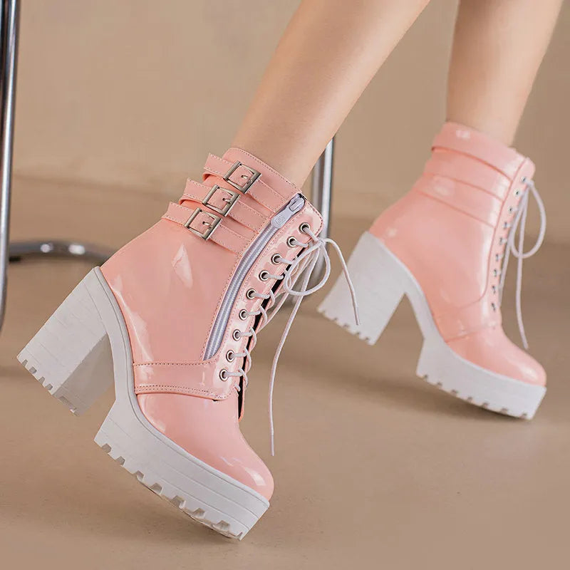 Women's black ankle boot with a thick rubber heel, round toe, and front lace-up closure on a waterproof platform.