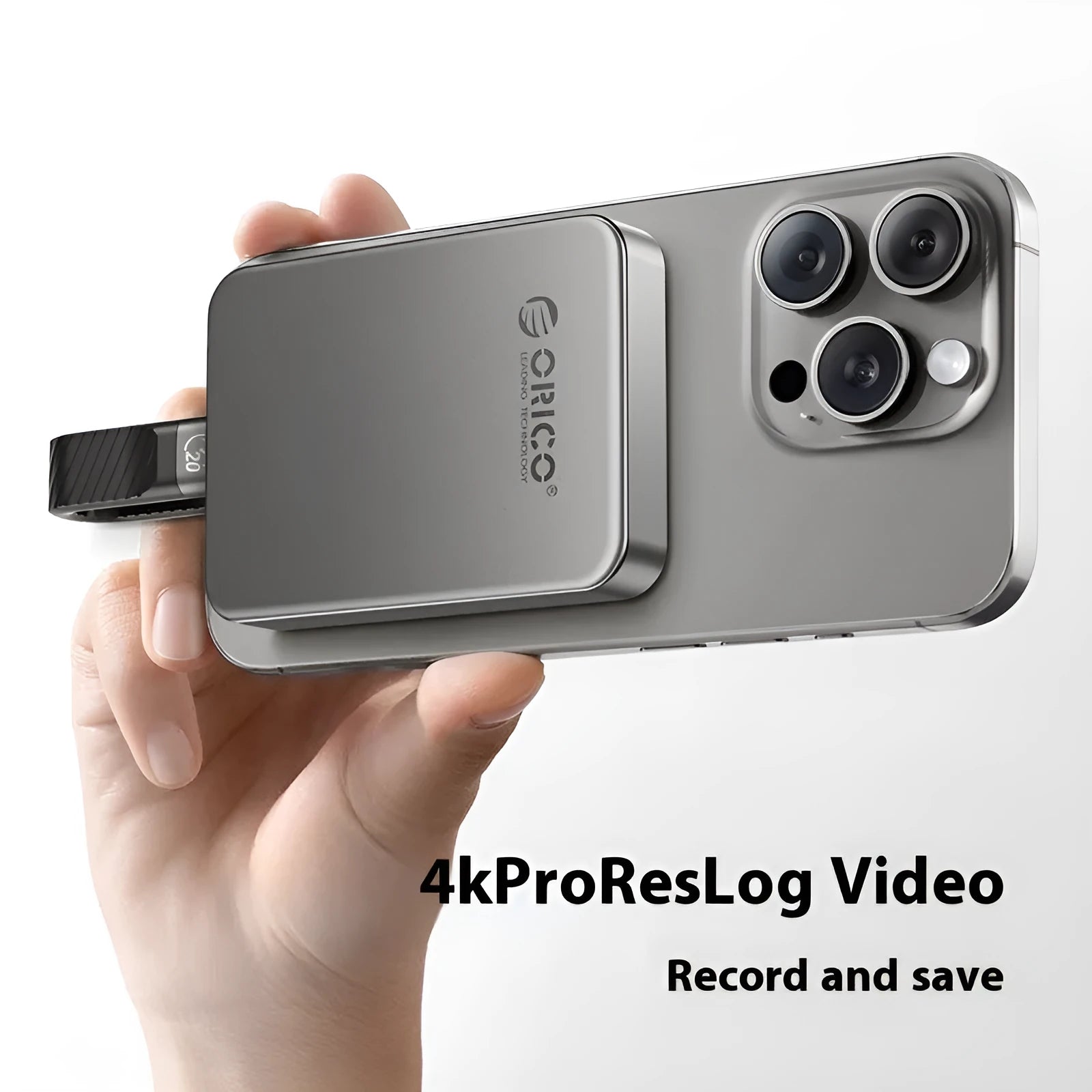 Grey magnetic mobile solid state drive with ultra-thin design next to its C to C cable and magnetic suction ring.