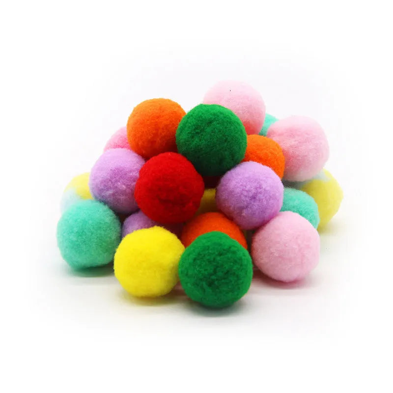 Plush ball launching gun for dogs next to a pile of soft coloured yarn balls.