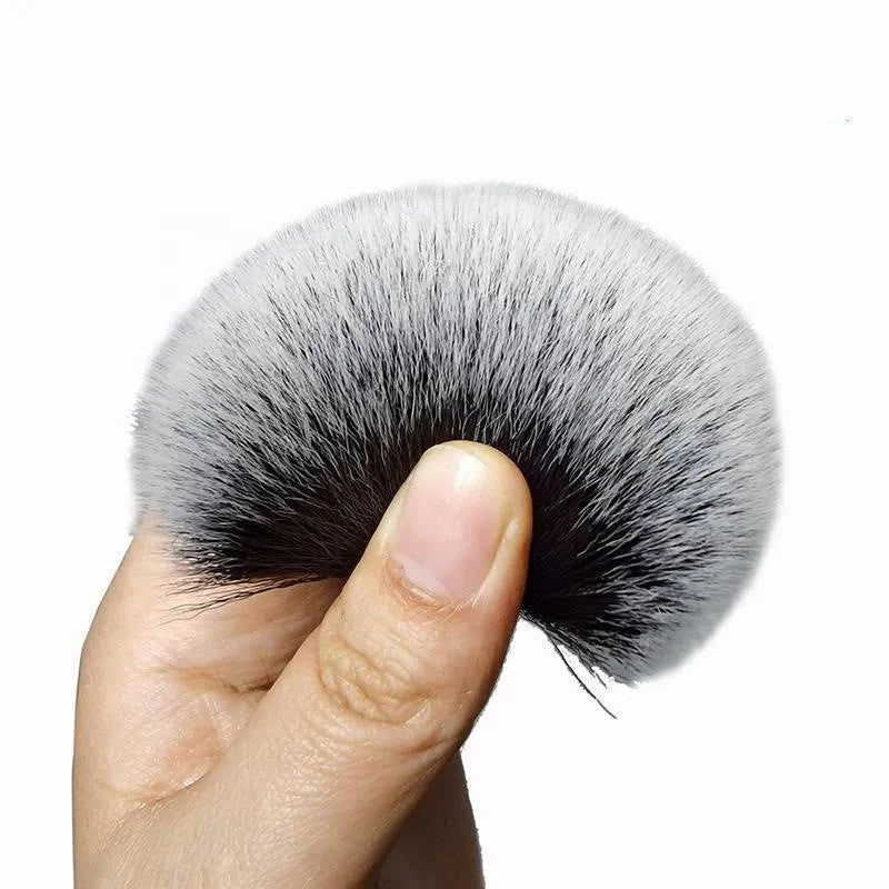 Black ultra-soft pig hair car detailing brush with PP plastic handle on a car seat.