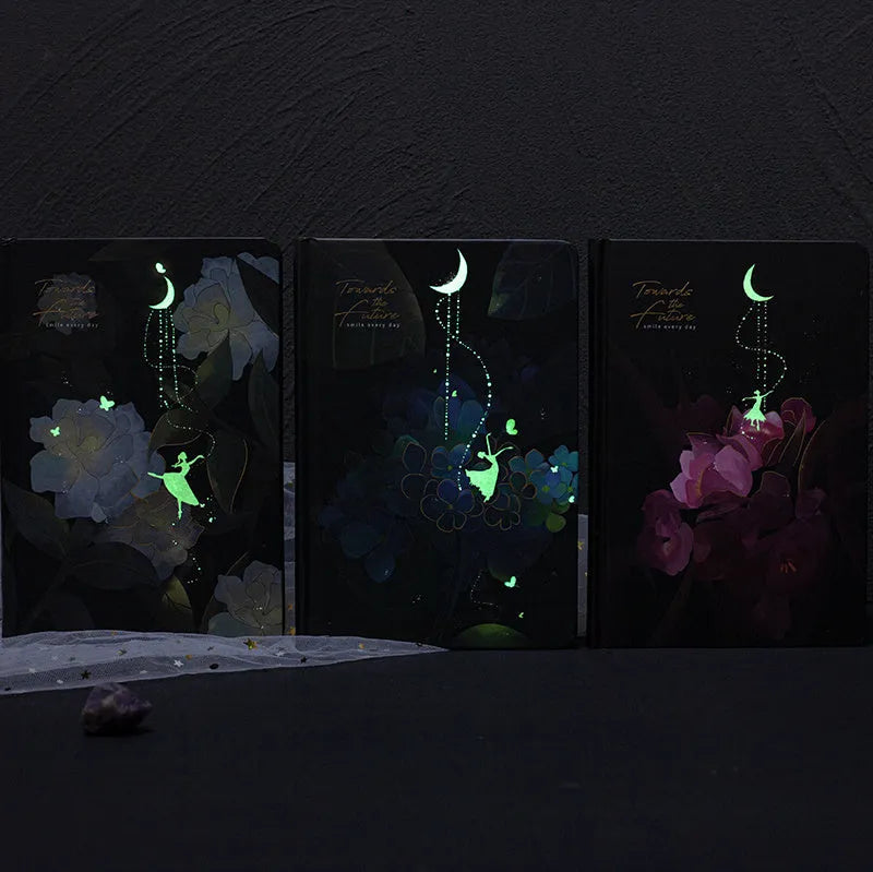 A5 size notebook with a luminous cover, open to show colour illustration pages and lined 160gsm paper.