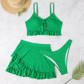 Women's white three-piece bikini set with a split hip skirt, made from polyester.