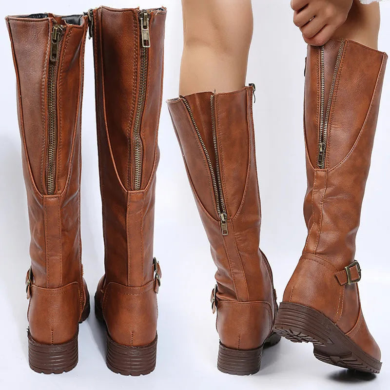 Women's solid colour knight boot with buckle detail, round toe, and square rubber heel.