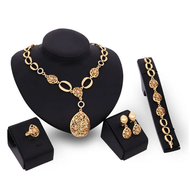 Gold alloy four piece jewellery set including necklace earrings bracelet and ring with bamboo link chain and love water drop bell patterns