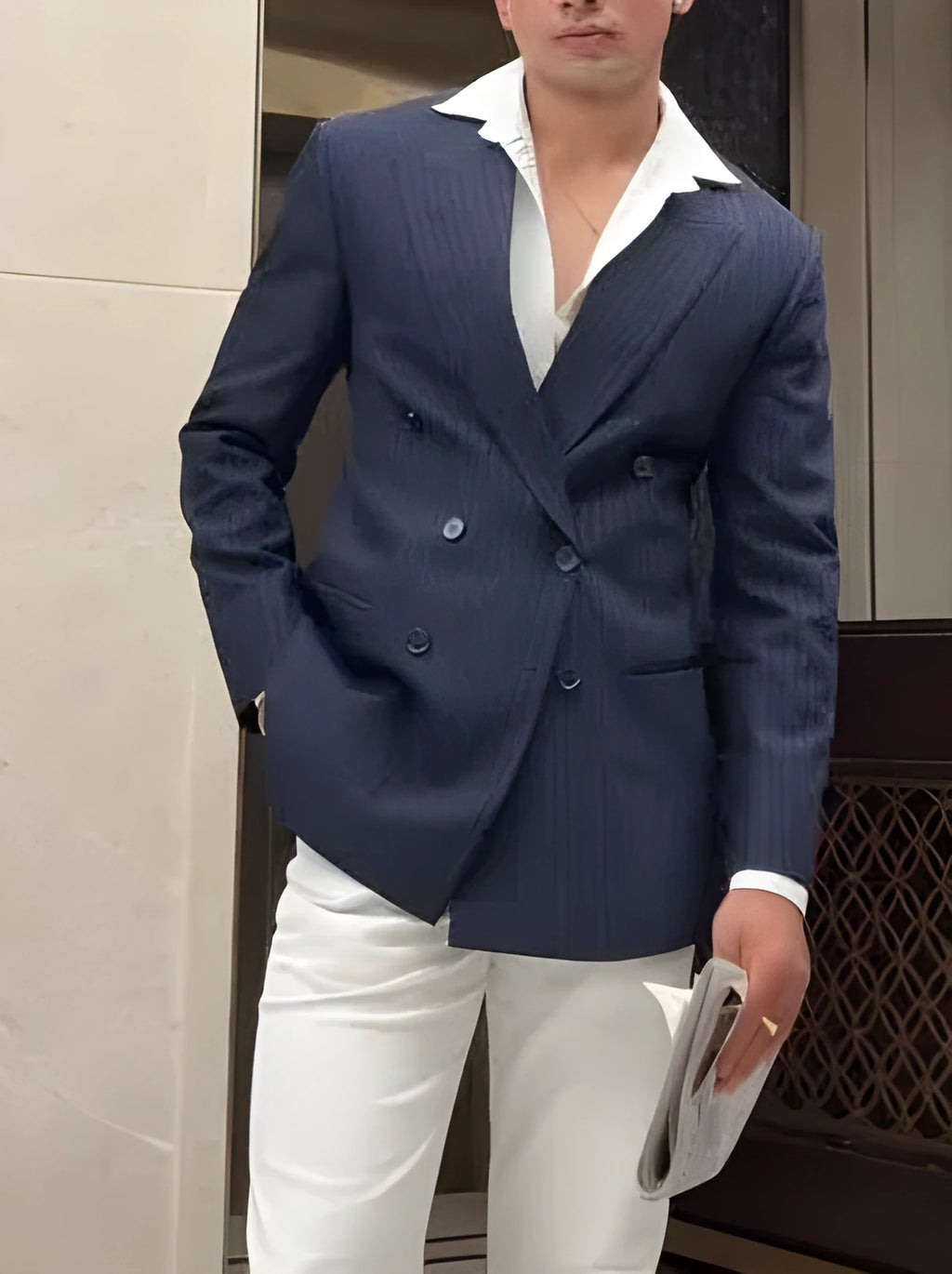 Men's classic striped double-breasted blazer on hanger showing front button fastening