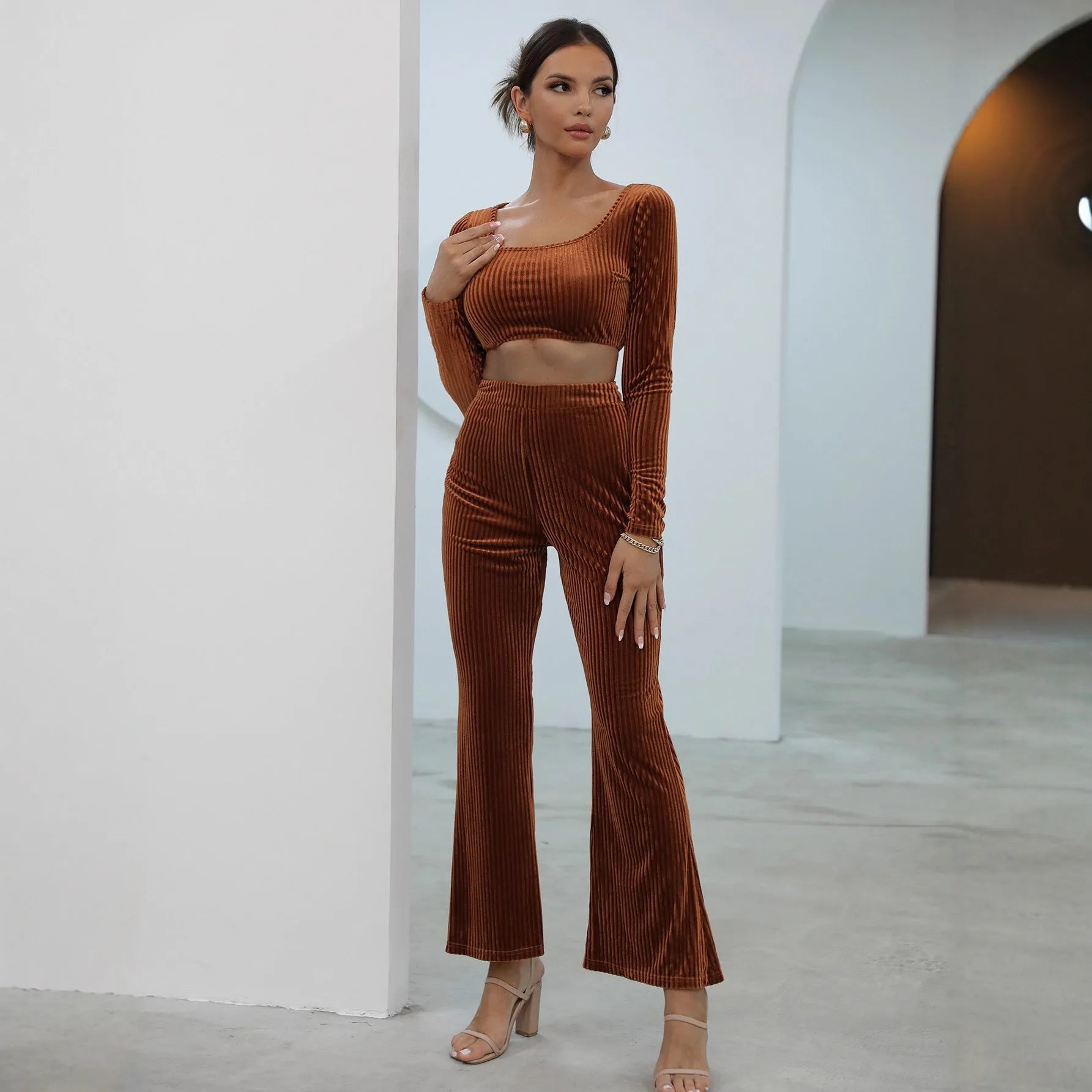 Caramel coloured women's long sleeve sweater and trouser casual set on a hanger.