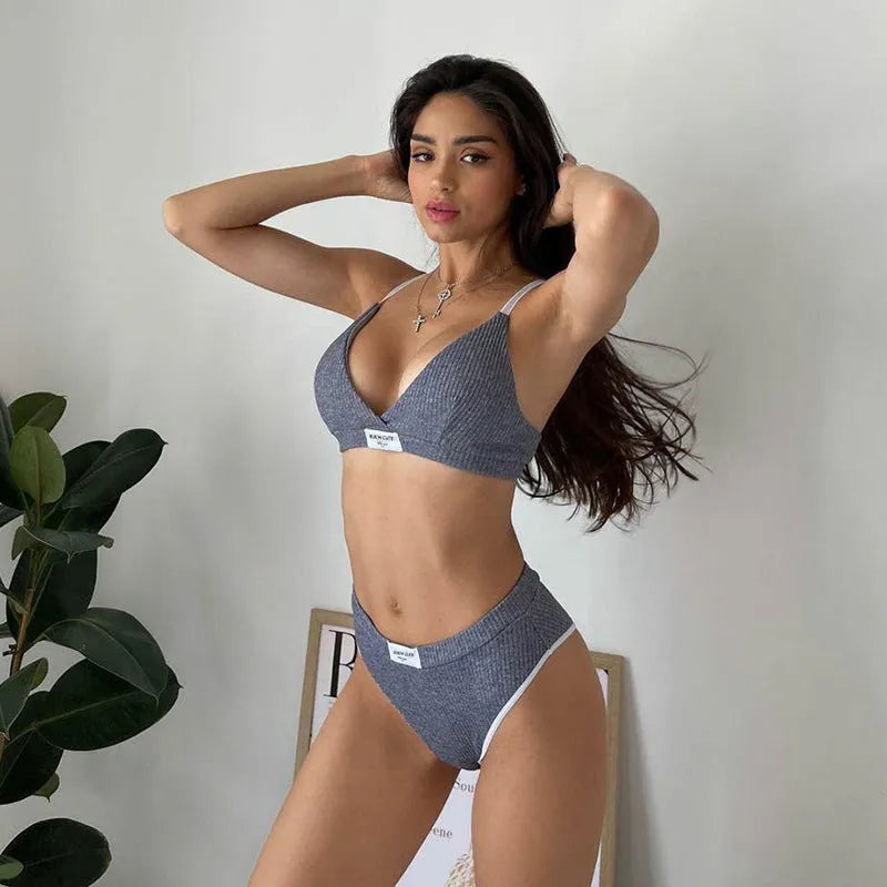 Women's grey bikini set with embroidery detailing and contrast binding on sleeveless top and shorts-length pants