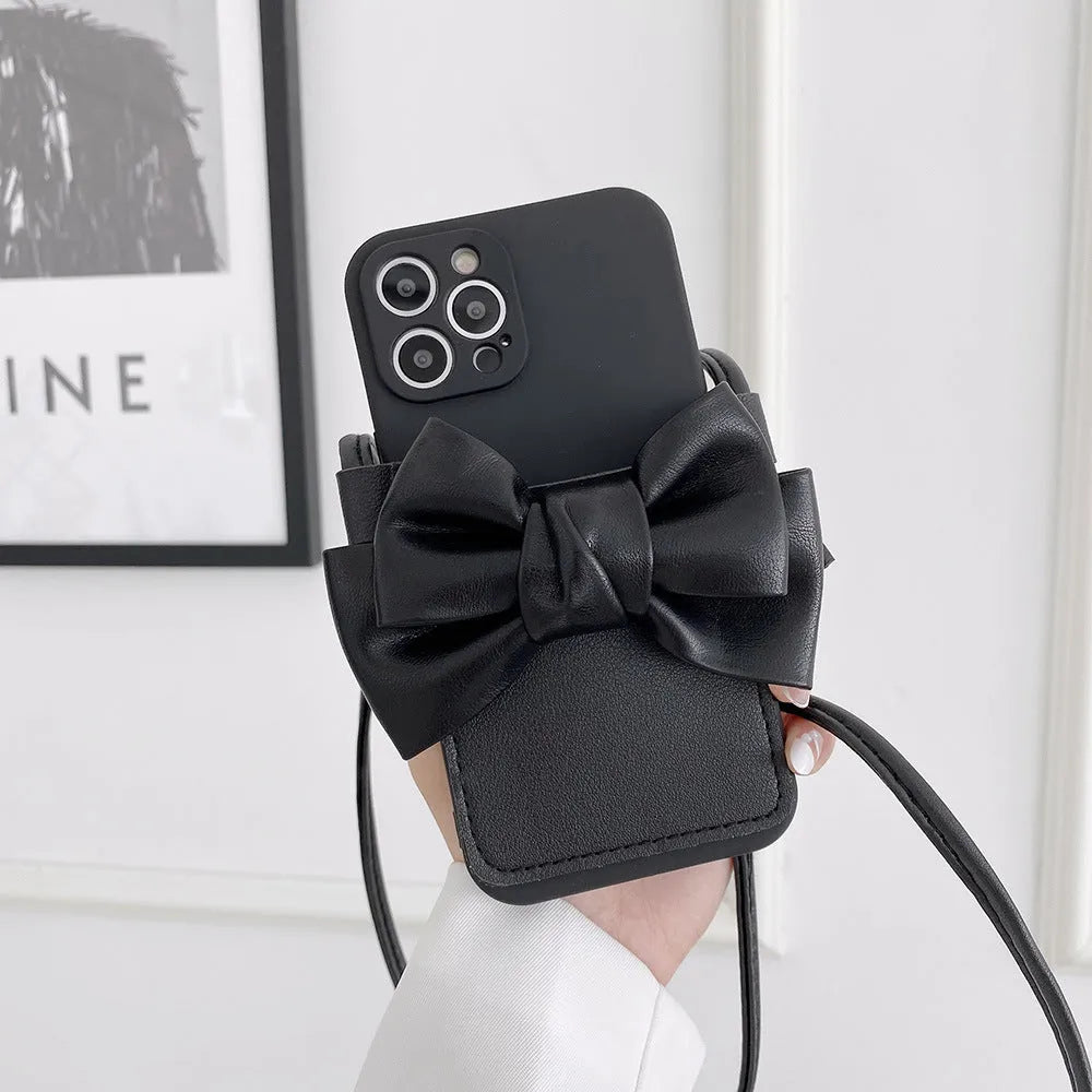 Ladies crossbody bag phone case in black with bow and strap showing iPhone in case front view