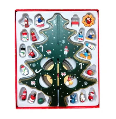 Hand painted wooden Christmas tree decorations in red and green colours on desktop