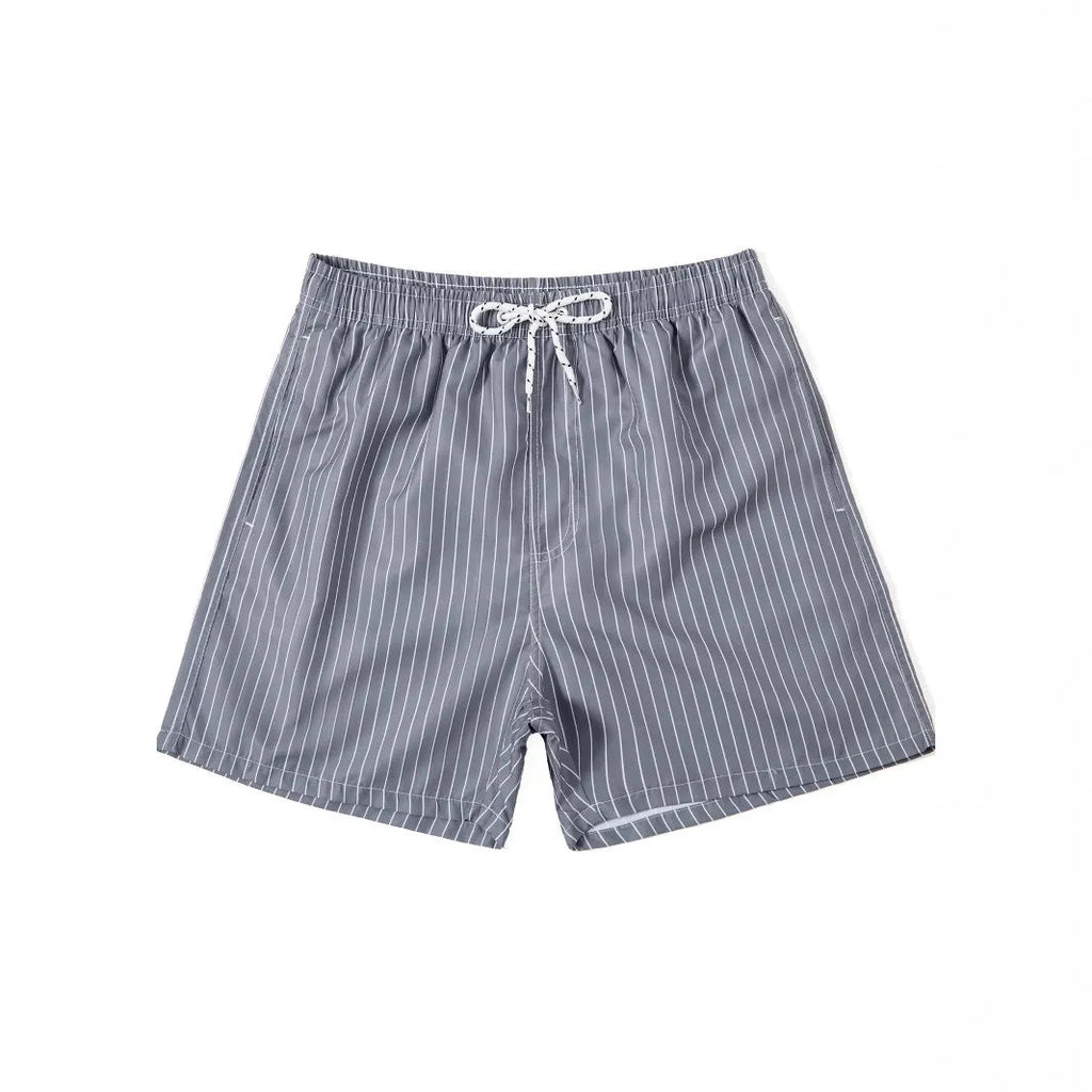 Striped polyester beach shorts in navy blue, shown with straight leg openings and triangle lining.