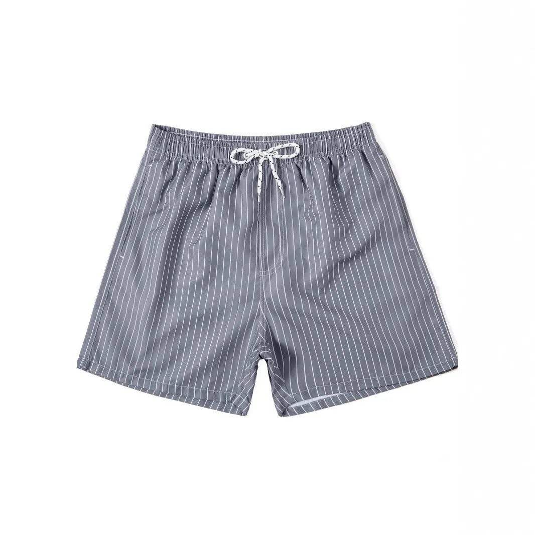 Striped polyester beach shorts in navy blue, shown with straight leg openings and triangle lining.