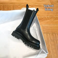 Women's black mid-calf boots with chunky low heel, round toe, and wear-resistant rubber sole in British style