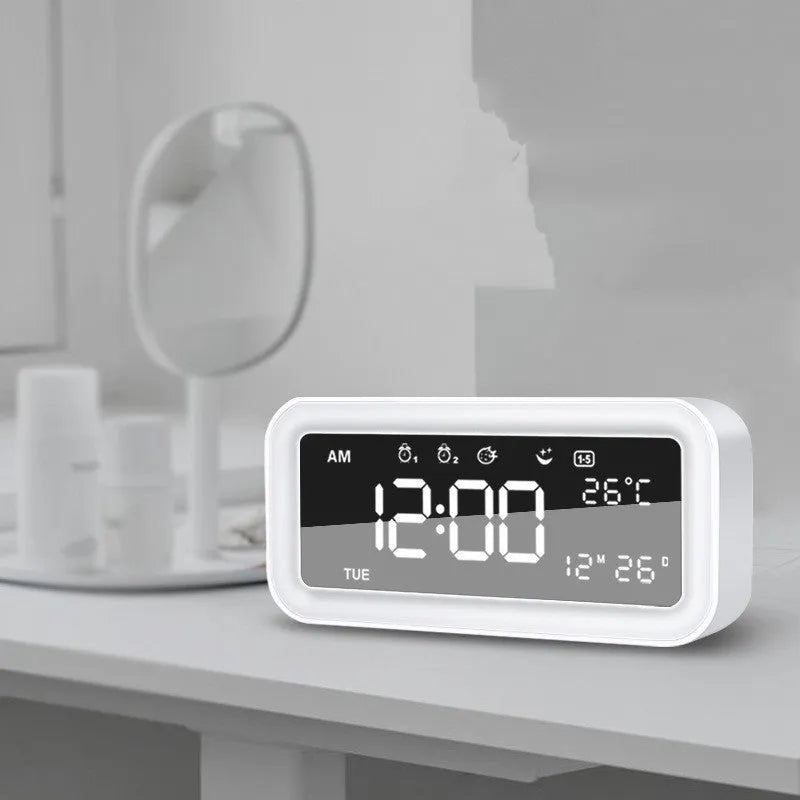 Blue rectangular LED multicoloured atmosphere light alarm clock with digital display on a desk.