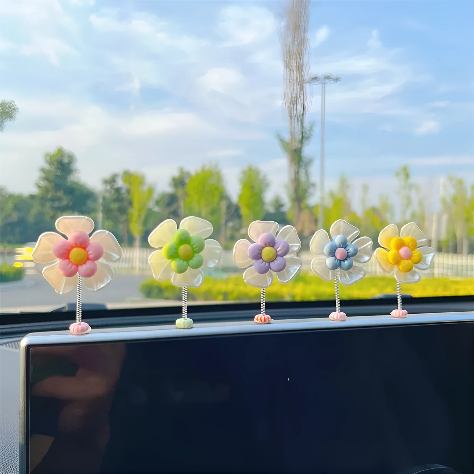Small blue plastic swing-shaped car dashboard decoration.