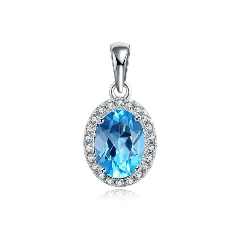 Women's sterling silver jewellery set with blue topaz stones, showing geometric earrings, necklace, ring, and pendant.