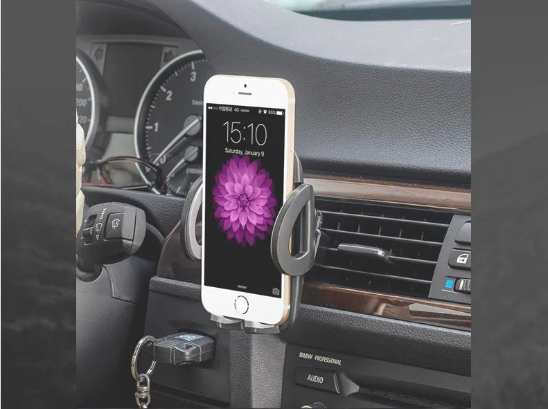 Universal black plastic car air vent mobile phone holder mounted on a car dashboard.