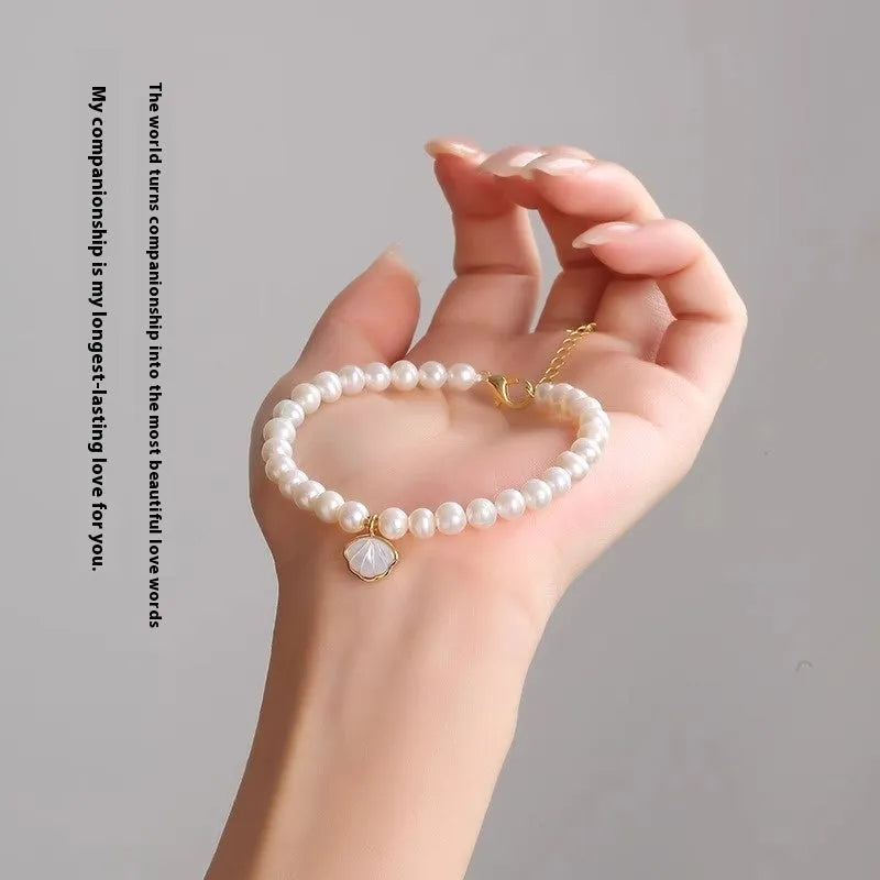 Women's freshwater pearl bracelet with fan-shaped design showing elastic and chain fastening options