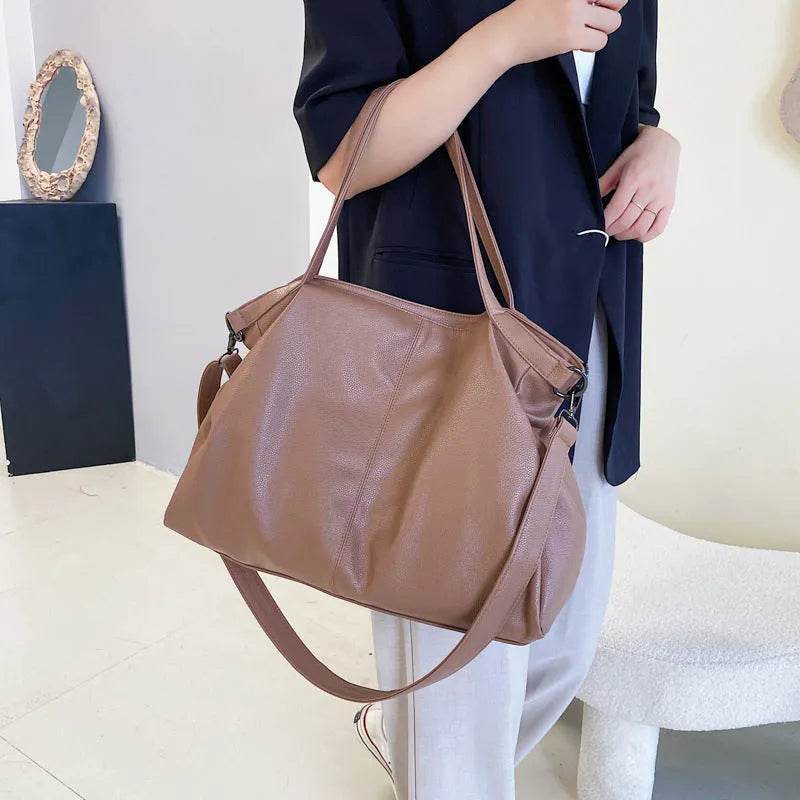 Large horizontal square soft PU messenger bag with zip and adjustable strap in four colour options.
