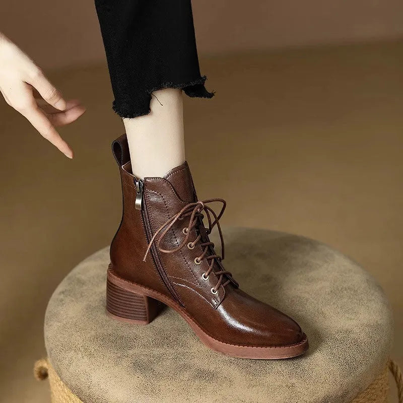 Women's black and brown pointed-toe ankle boots with a 5.5cm heel on a plain background