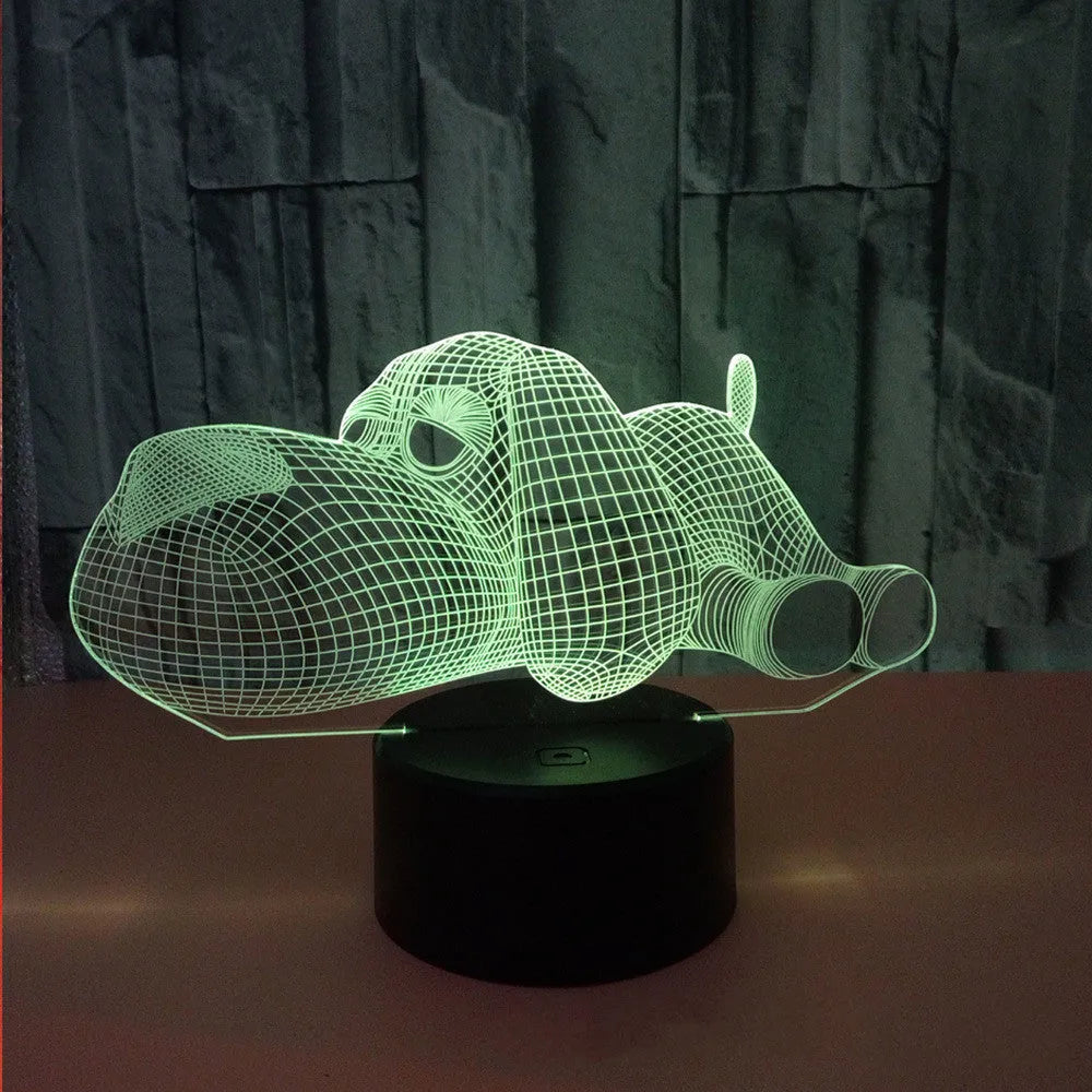 Doggo desktop lamp with 3D illusion design glowing in multiple colours on a desk.