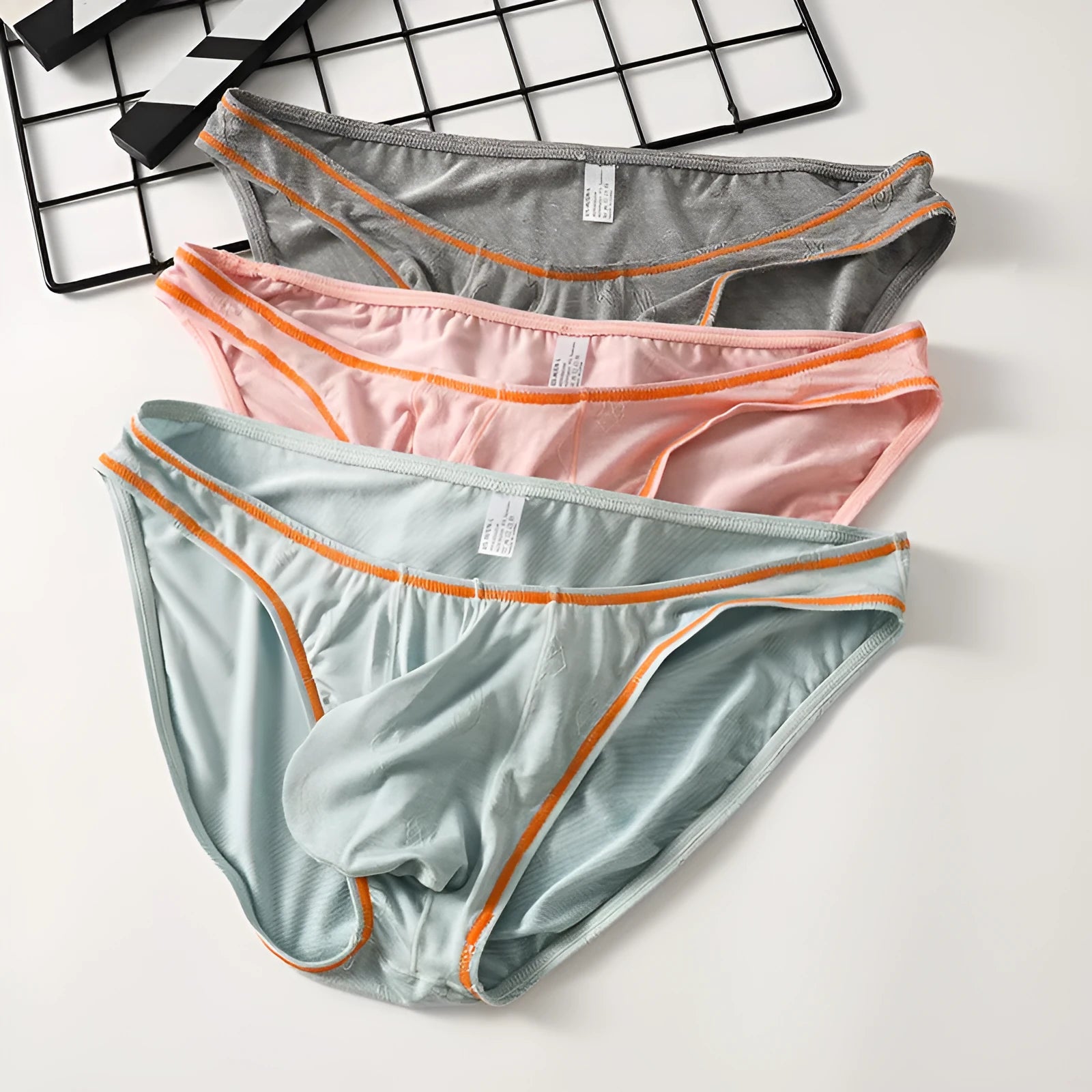 Men's dark grey modal underwear with butt-lift design on a white background