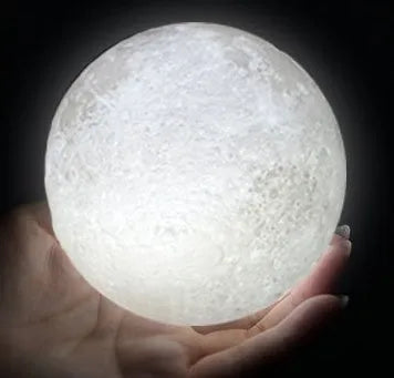 3D printed white moon lamp with detailed craters on a wooden stand, showing touch ring at base