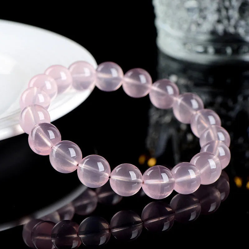 Natural starlight crystal round bead bracelet in pink with polished beads in multiple size options