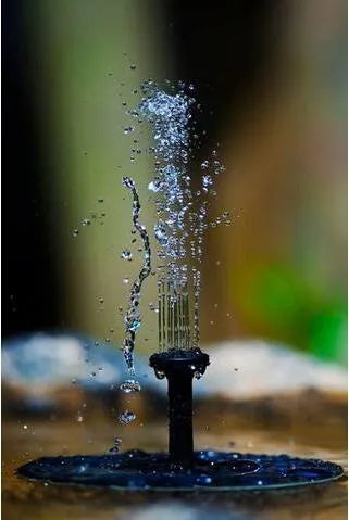 Black solar-powered water fountain pump with four spray nozzles on a 16x16cm base.