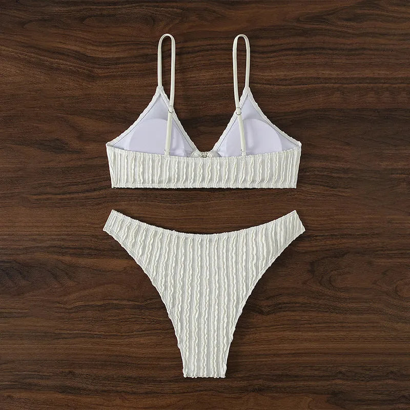 White women's V-neck swimsuit with sleeveless design and beach split styling