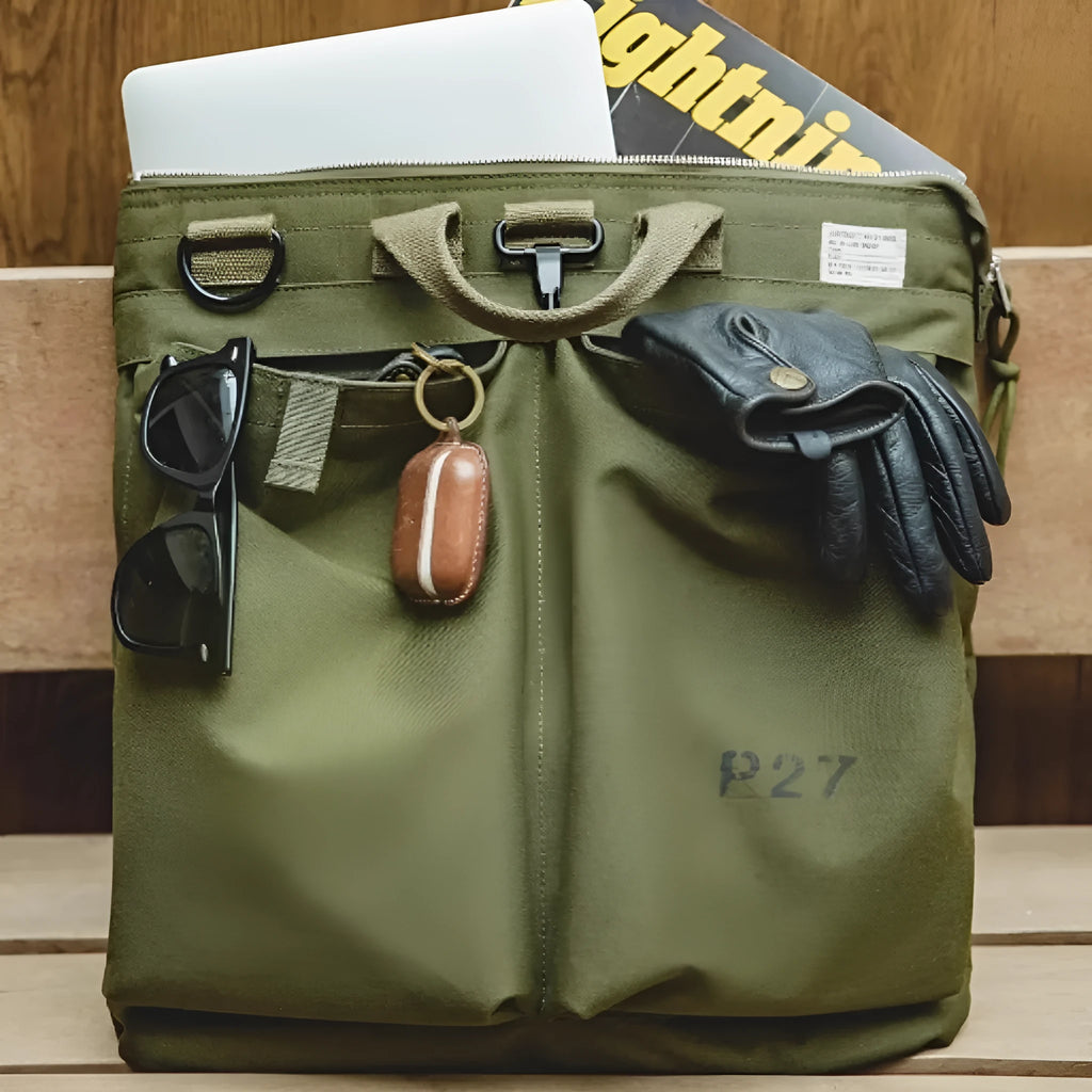 Military green canvas messenger bag with shoulder strap and zip closure showing internal phone pocket