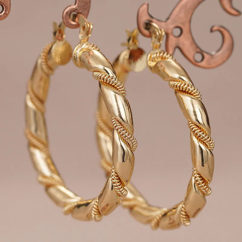 Women's geometric copper earrings with clip-on design in golden colours featuring ring and line elements