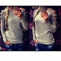 Women's grey hollow-out crochet knitted long sleeve shirt with round neck on a hanger.